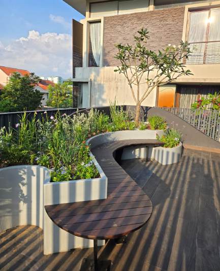 Custom curved planter and bench, floral balcony garden